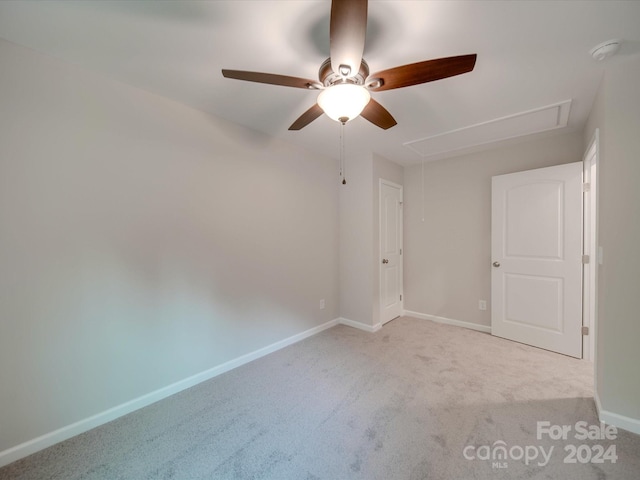 spare room featuring ceiling fan and light colored carpet