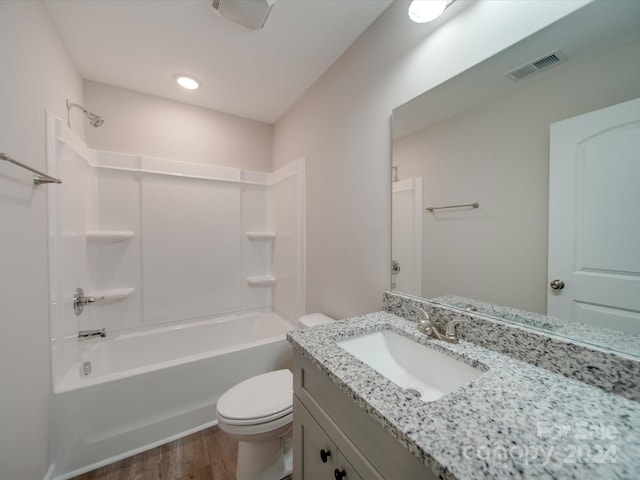 full bathroom featuring bathing tub / shower combination, vanity, toilet, and hardwood / wood-style flooring