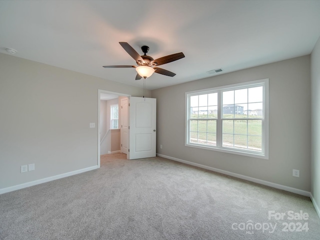 unfurnished bedroom with ceiling fan and light colored carpet