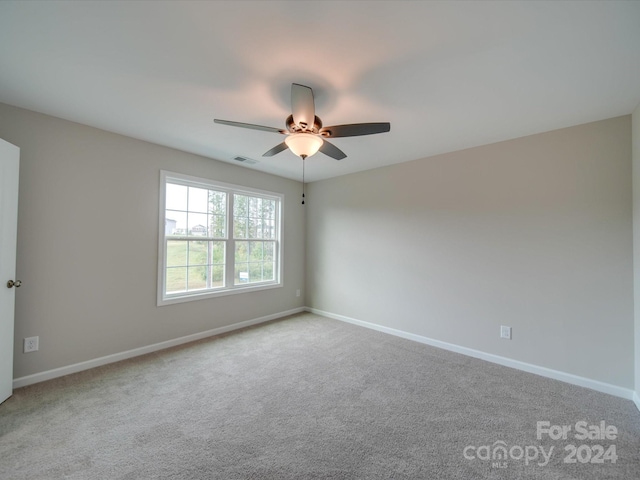 unfurnished room with ceiling fan and light colored carpet