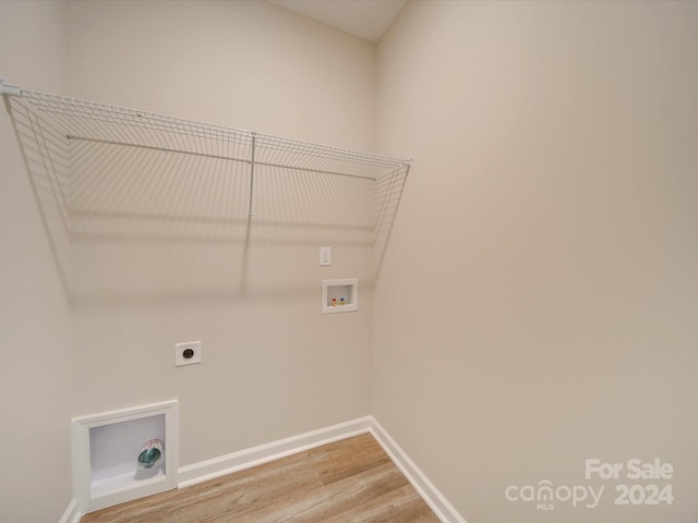 laundry area with hookup for a washing machine, electric dryer hookup, and hardwood / wood-style flooring