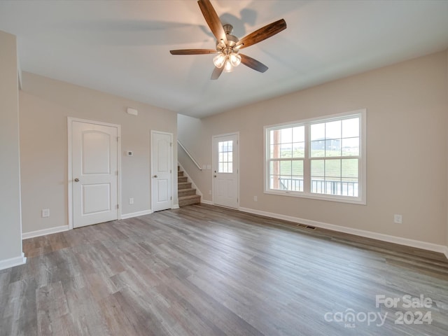 empty room with light wood-type flooring and ceiling fan