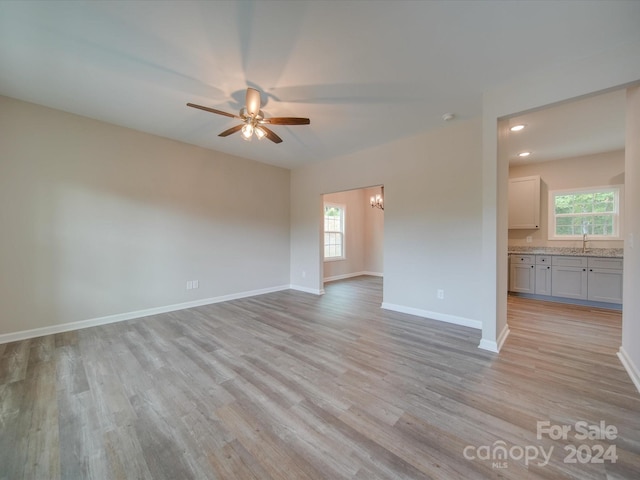 empty room with ceiling fan, light hardwood / wood-style flooring, and a wealth of natural light