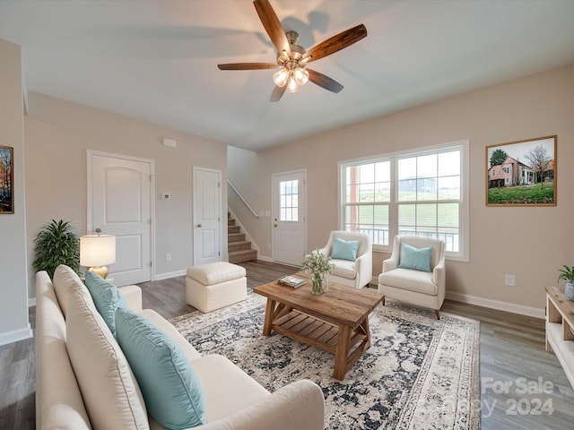 living room featuring wood-type flooring and ceiling fan