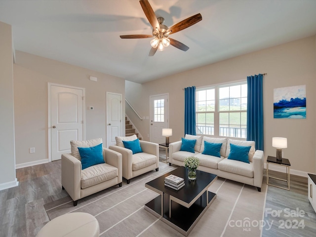 living room featuring ceiling fan and light hardwood / wood-style floors