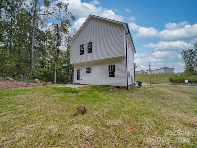 rear view of house featuring a yard