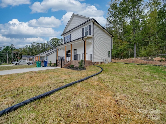 view of front of house featuring covered porch and a front yard