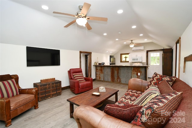 living room featuring ceiling fan, light hardwood / wood-style flooring, a wall mounted AC, and vaulted ceiling