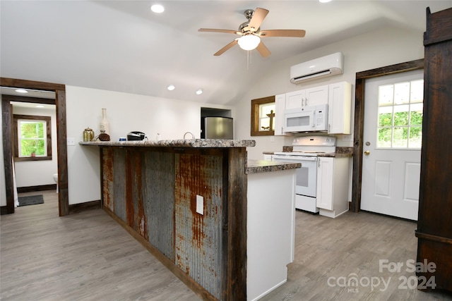 kitchen with a wall mounted air conditioner, ceiling fan, white appliances, and light wood-type flooring