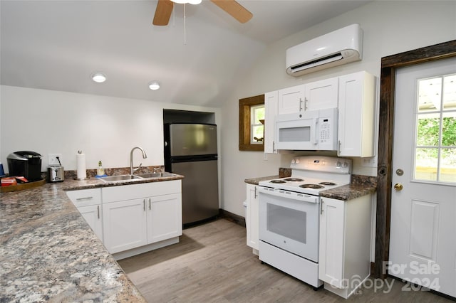 kitchen with white appliances, light wood-type flooring, sink, ceiling fan, and a wall mounted AC