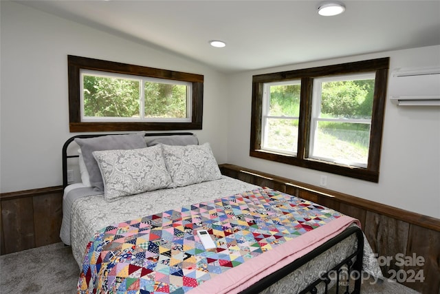 bedroom featuring lofted ceiling and a wall mounted AC