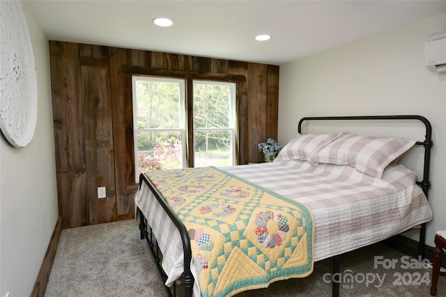 bedroom featuring wooden walls, an AC wall unit, and carpet floors