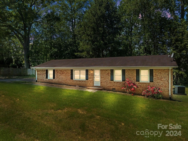 single story home with central AC and a front lawn