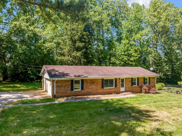 single story home featuring a garage and a front lawn