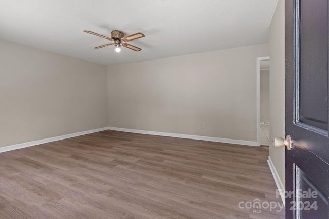 spare room with wood-type flooring and ceiling fan