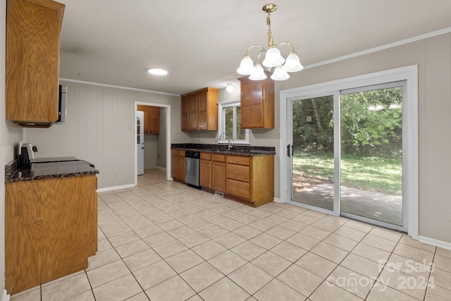 kitchen with light tile flooring, a notable chandelier, range, stainless steel dishwasher, and pendant lighting