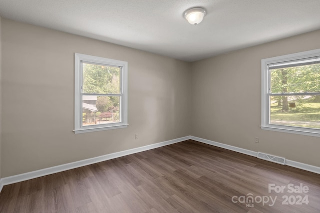 unfurnished room featuring dark hardwood / wood-style floors