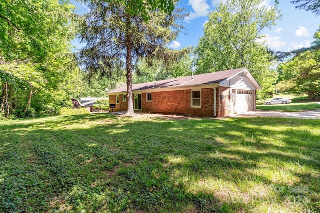 exterior space with a garage and a yard