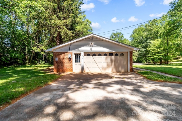 garage featuring a lawn