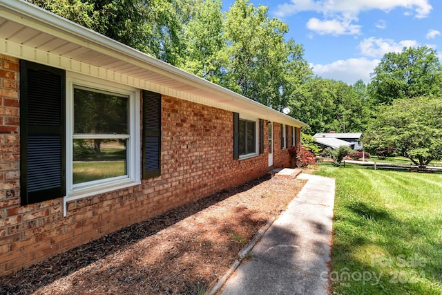 view of side of property with a yard