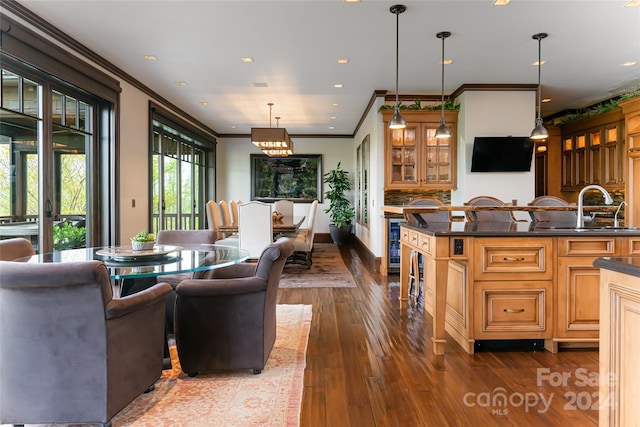 interior space with beverage cooler, sink, dark hardwood / wood-style flooring, and ornamental molding