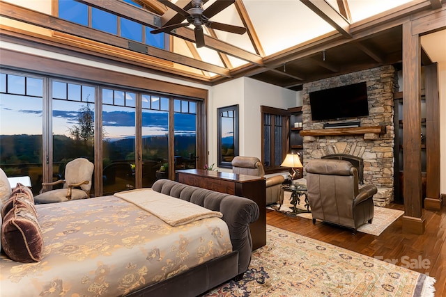 bedroom with a fireplace, hardwood / wood-style flooring, beam ceiling, coffered ceiling, and ceiling fan