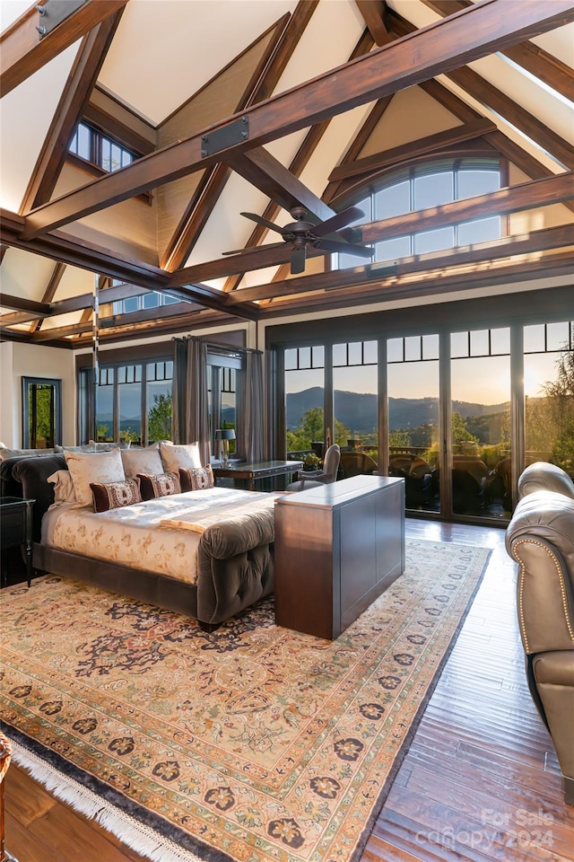 living room with high vaulted ceiling, beam ceiling, plenty of natural light, and hardwood / wood-style flooring