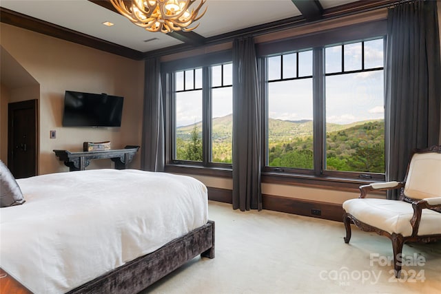 carpeted bedroom featuring crown molding and an inviting chandelier