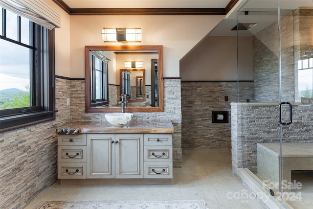 bathroom with tile floors, ornamental molding, an enclosed shower, and vanity