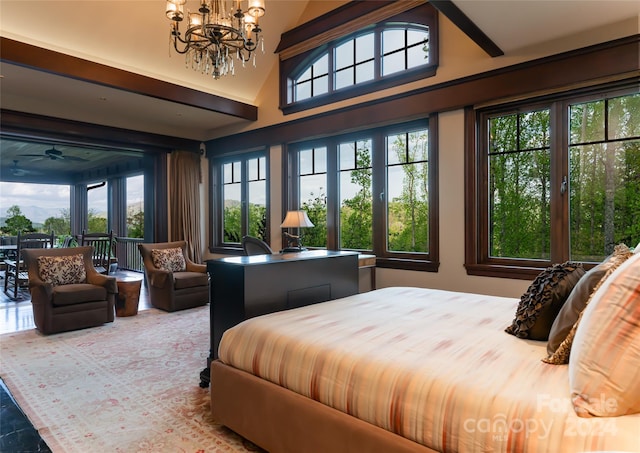 bedroom with a towering ceiling, a chandelier, and multiple windows