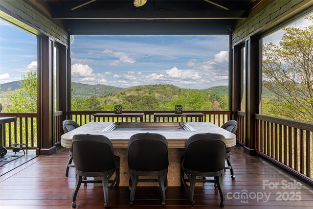 sunroom with a wealth of natural light and a mountain view