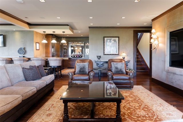 living area featuring stairs, indoor bar, wood finished floors, and crown molding