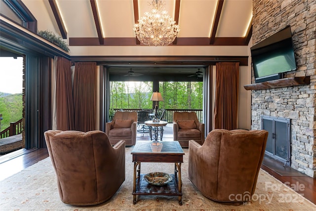 living room with beam ceiling, a fireplace, wood finished floors, high vaulted ceiling, and ceiling fan with notable chandelier