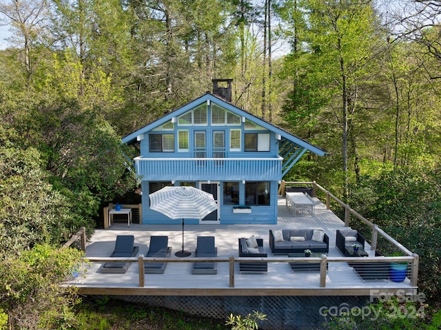 back of property with outdoor lounge area and a deck