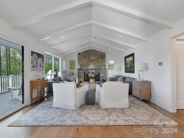 living room featuring hardwood / wood-style floors, lofted ceiling with beams, and a fireplace