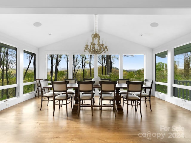 sunroom / solarium with vaulted ceiling and an inviting chandelier