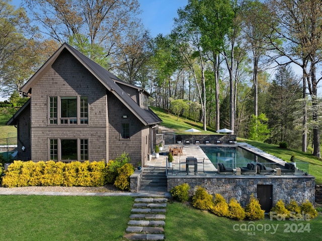 exterior space featuring a fenced in pool and a yard