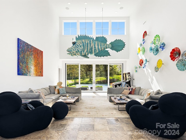 living room featuring french doors and a high ceiling