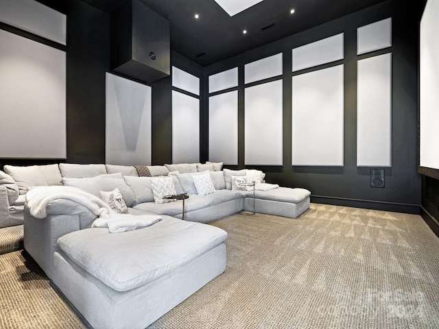 carpeted cinema room featuring a towering ceiling