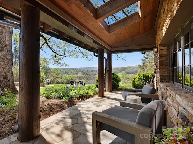 view of patio / terrace with a view of trees