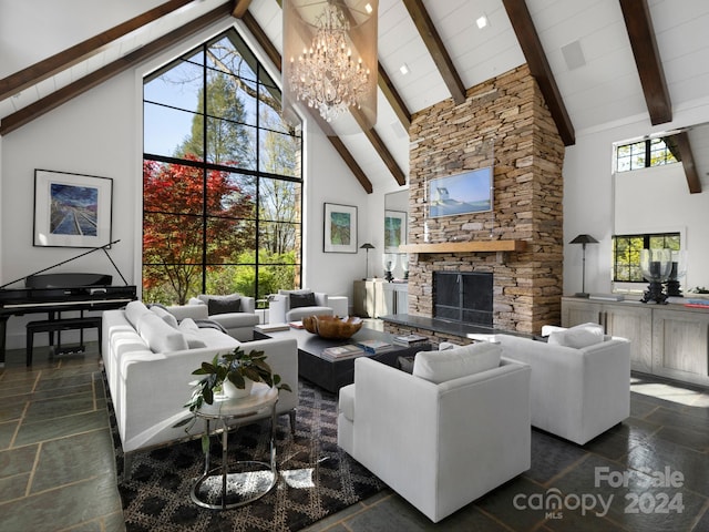 living room with a wealth of natural light, a fireplace, and high vaulted ceiling