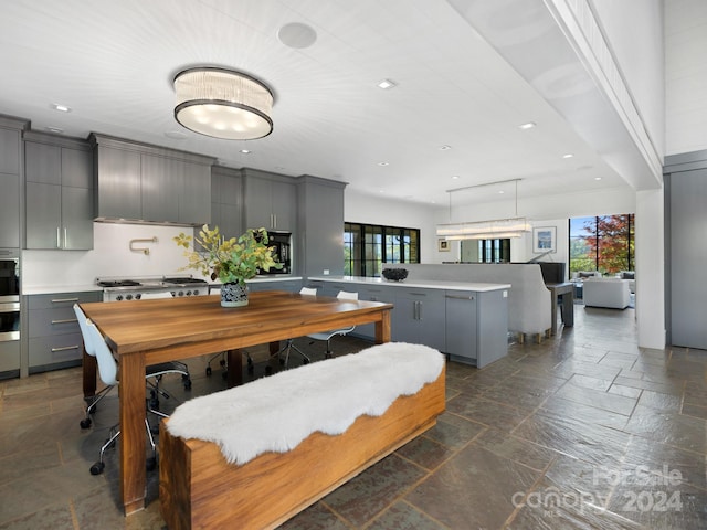 dining room with recessed lighting and stone tile flooring