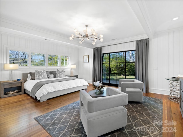 bedroom featuring beam ceiling, a notable chandelier, wood-type flooring, crown molding, and baseboards