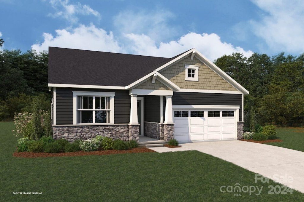 craftsman inspired home featuring a garage and a front yard