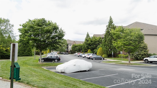 view of car parking featuring a yard