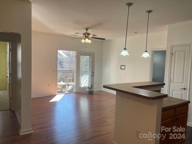 kitchen featuring decorative light fixtures, dark hardwood / wood-style floors, and ceiling fan