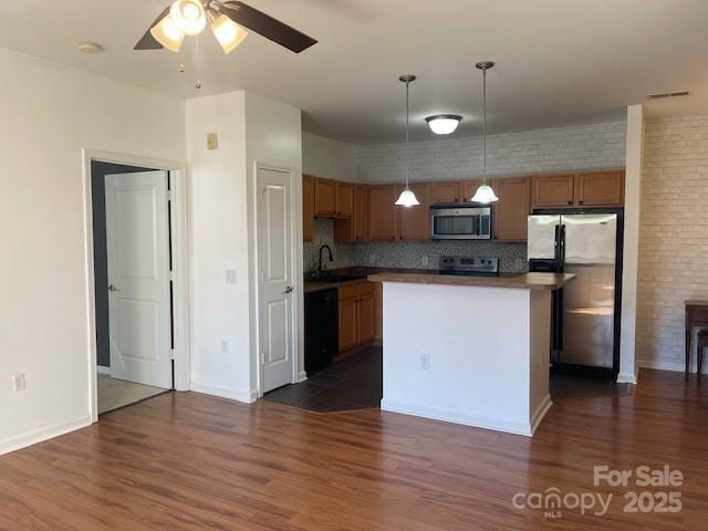 kitchen with pendant lighting, a ceiling fan, stainless steel appliances, and dark wood-style floors