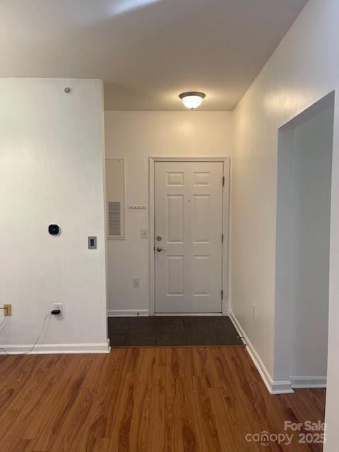 interior space featuring baseboards and wood finished floors