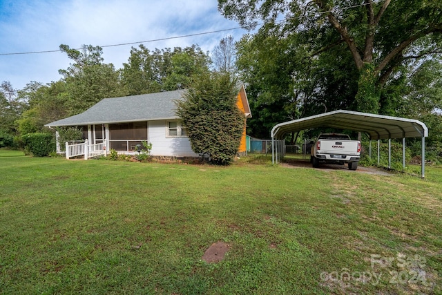 view of yard with a carport and covered porch