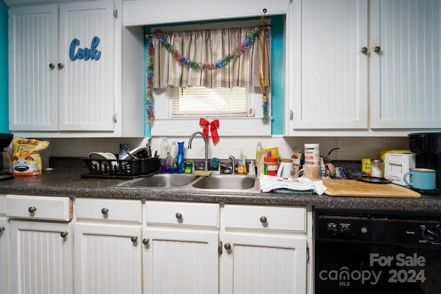 kitchen featuring dishwasher, white cabinets, and sink